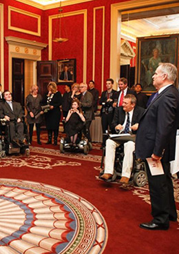 Guests assembling in a hallway with disabled people in wheel chairs